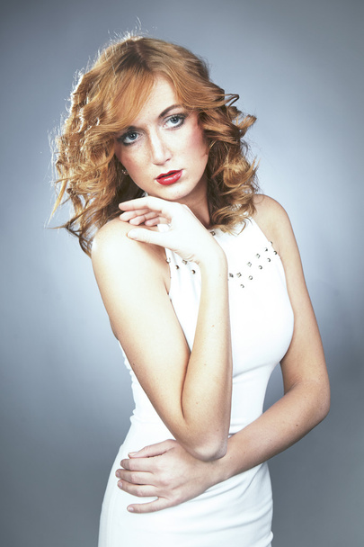 Model with red hair posing in studio - Photo, Image