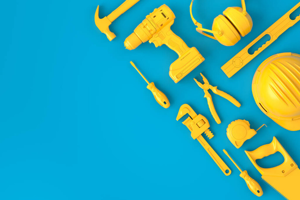 Top view of monochrome construction tools for repair on blue and yellow - Foto, Imagem