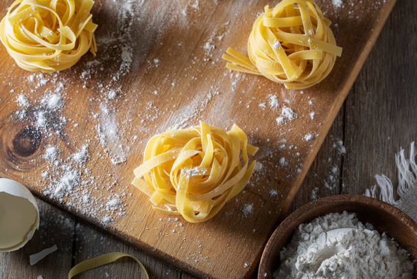 Homemade pasta on a rustic table - Foto, afbeelding