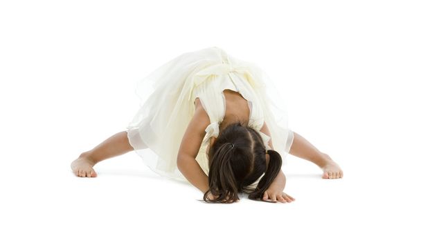 Little girl trying to do the splits, isolated on white background - Foto, imagen