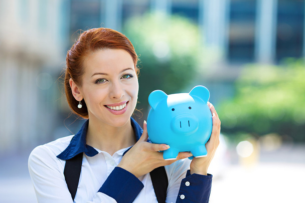 Happy woman, corporate employee holding piggy bank - Foto, Imagen