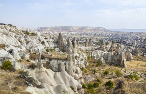 Unique fancy geological mountain formations with dovecotes of the Pigeon valley in Goreme, Cappadocia, Turkey - Fotó, kép