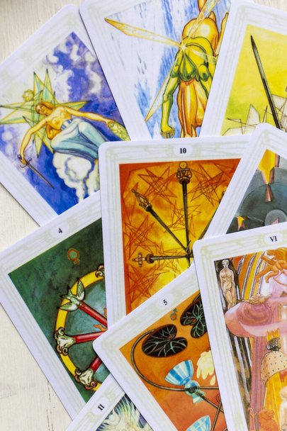 Moscow, Russia, June 11, 2021: Tarot cards are scattered on the table, close-up, fragment. - 写真・画像