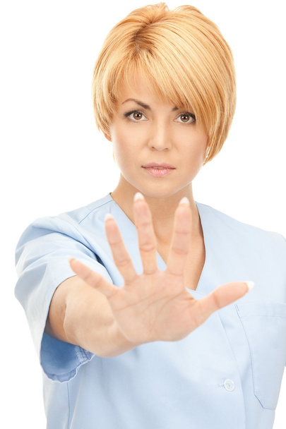 Bright picture of attractive female doctor showing stop gesture - Фото, зображення