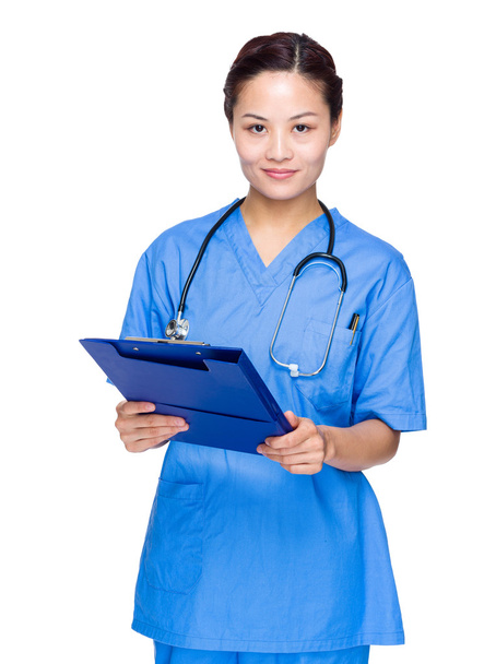 Woman doctor with clipboard - Фото, изображение