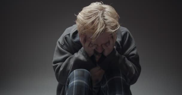 Jeune garçon étendu et essayant de ne pas pleurer à propos de la douleur en lui - Séquence, vidéo