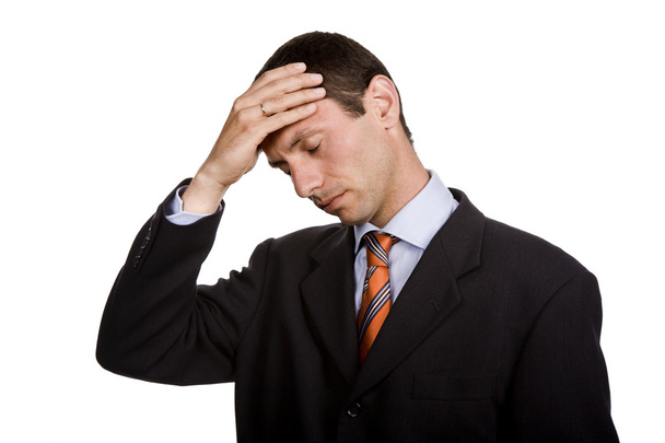 Businessman in a suit gestures with a headache - Photo, Image