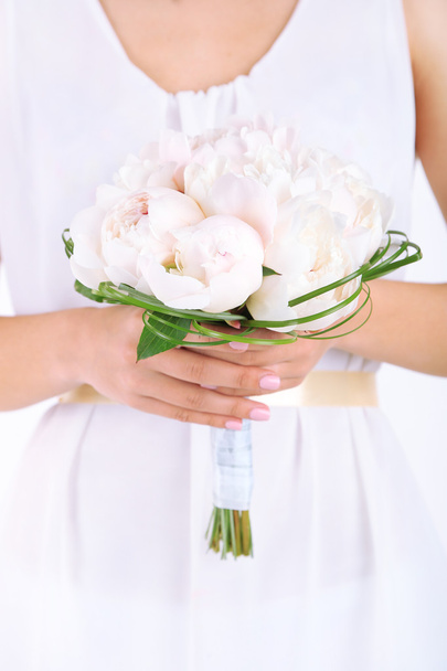 Bride holding wedding bouquet of white peonies - 写真・画像