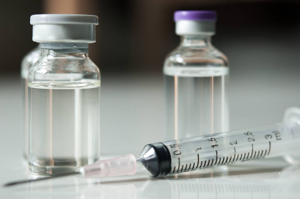 Selective Focus of Syringe and Medicine in vial , ready for vaccine injection , Cancer Treatment , Pain Treatment and can also be abused for an illegal use, healthcare and medical concept vaccination. - Photo, image