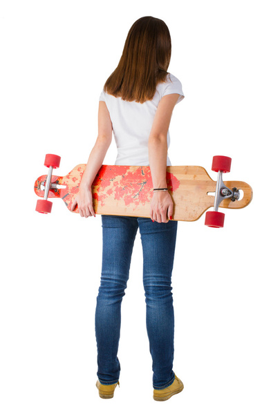Woman holding skateboard - Foto, afbeelding