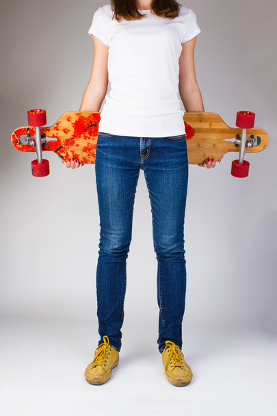 Woman holding skateboard - Fotó, kép