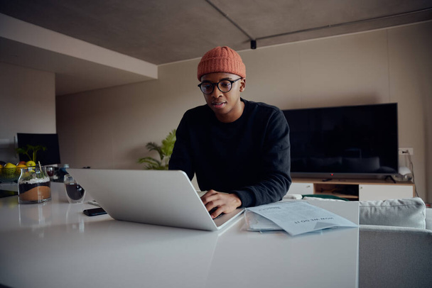 African American male working from home using laptop. Happy African American male working from home. High quality photo  - Zdjęcie, obraz