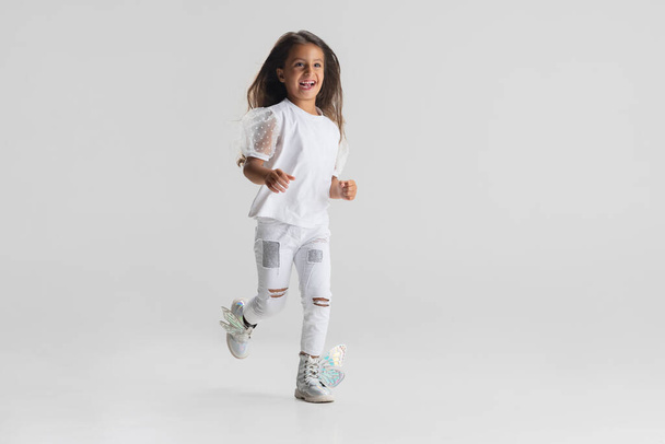 One little Caucasian cute girl posing isolated over white studio background. - Valokuva, kuva