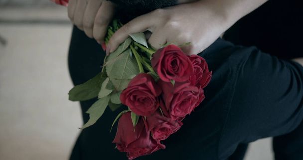 The red roses in the hand of an Indian woman hugging her boyfriend - Photo, Image