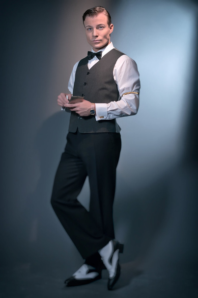 Retro classic business fashion man wearing grey gilet and bow ti - Photo, Image