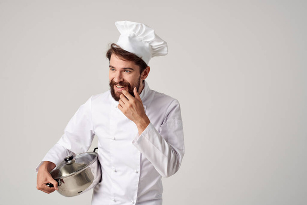 bebaarde mannelijke chef-kok met steelpan in handen keuken restaurant professioneel - Foto, afbeelding