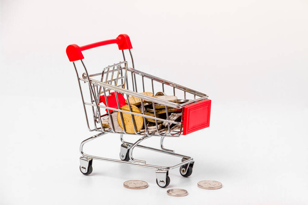 Small Israeli coins in a supermarket trolley. Side view. - Photo, Image