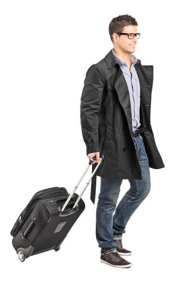 Young man carrying his luggage - Фото, зображення