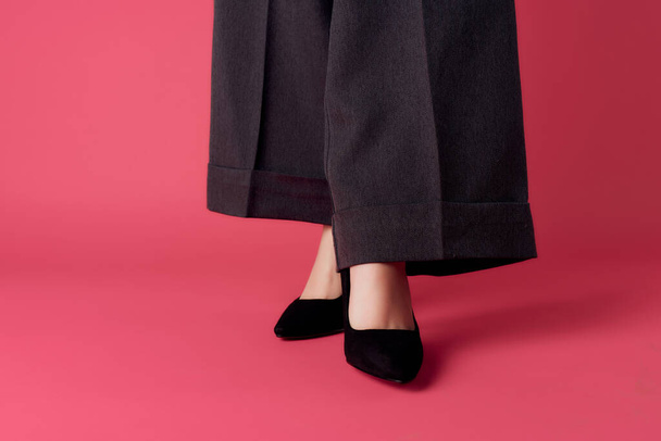 female legs in black pants shoes posing elegant style fashion - Fotó, kép