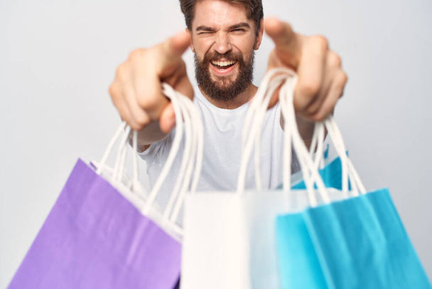 man with bags in his teeth shopping lifestyle fun - Foto, imagen
