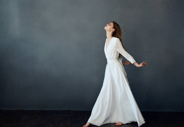 woman white dress fashion elegant style studio dark background posing - Фото, зображення
