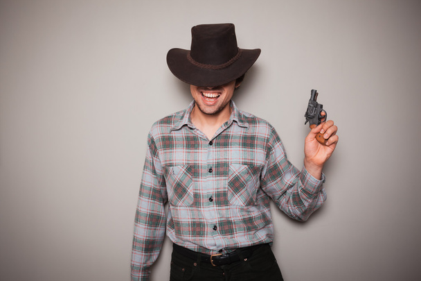 Young cowboy with a gun - Φωτογραφία, εικόνα