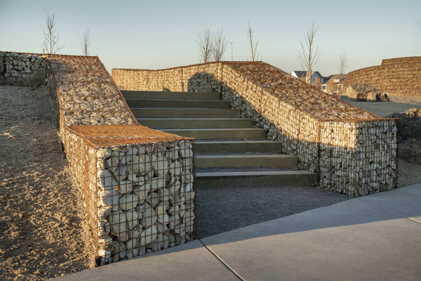 Staircase with wooden riser in between the gabion retaining walls - Photo, Image