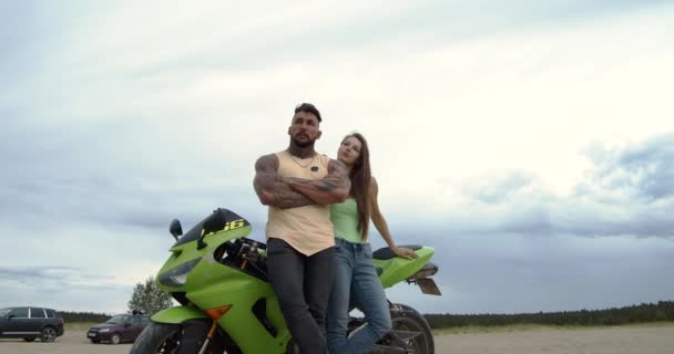 Κομψό ζευγάρι με μοτοσικλέτα στην παραλία - Πλάνα, βίντεο