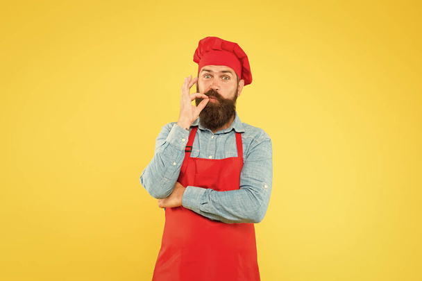Delicious food on time. satisfied bearded chef. brutal butcher in apron. best menu offer. confident happy chef white uniform. sign for delicious. Male chef in red uniform. hipster with happy face - Photo, Image