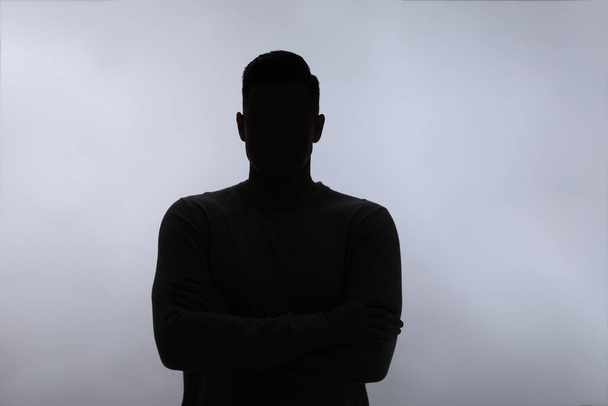 Silhouette of anonymous man on white background - Foto, afbeelding