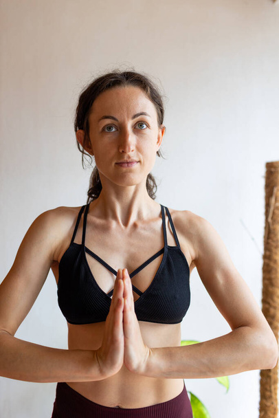 healthy and beautiful body concept. Beautiful brunette fitness woman meditate, doing yoga indoors at home. Staying fit and healthy - Valokuva, kuva