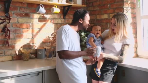 Medium shot of mixed race family of three spending time at the kitchen. - Filmati, video