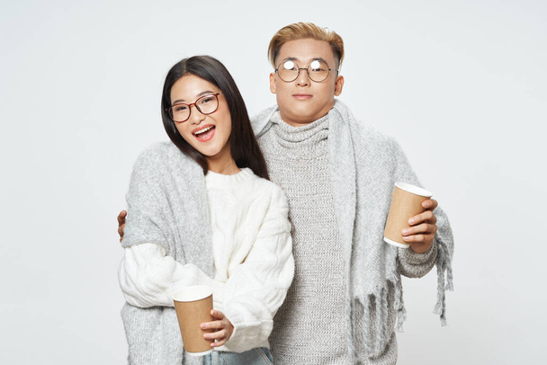 young couple asian appearance winter clothing fashion hot drinks - Zdjęcie, obraz