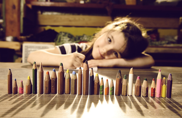 Little girl playing with pencils - Photo, Image