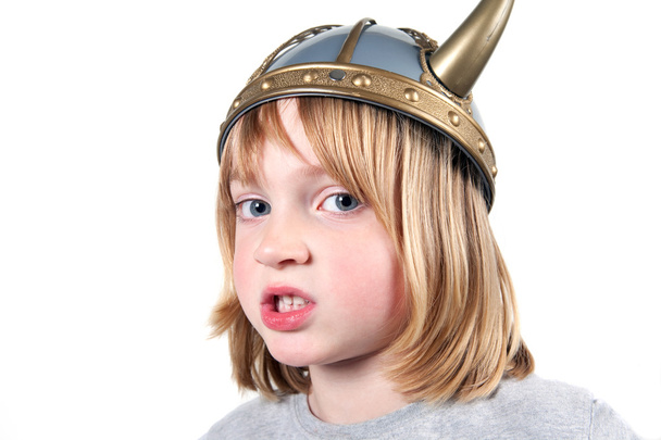 Злой ребенок в шлеме викинга. мальчик, изолированный на белом с выражением агрессии. блондин, одетый
 - Фото, изображение