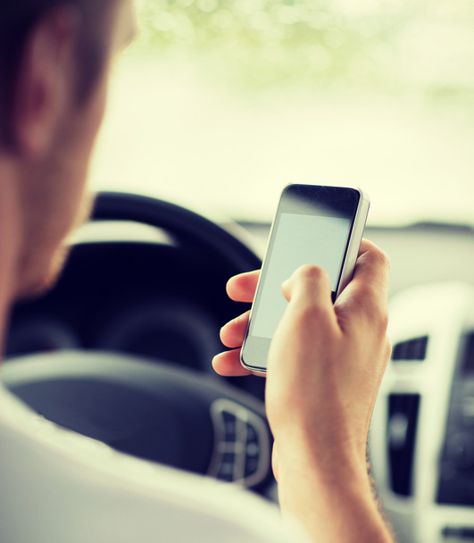 man using phone while driving the car - Zdjęcie, obraz