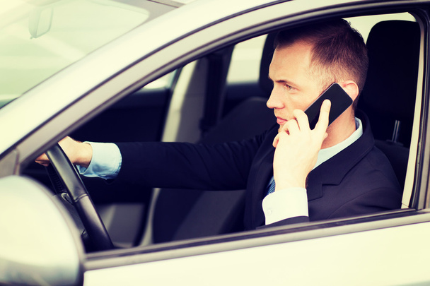 man using phone while driving the car - Zdjęcie, obraz