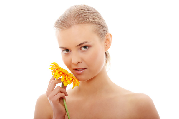 Portrait of the attractive girl without a make-up, with flower in hand, isolated on white background - Foto, afbeelding