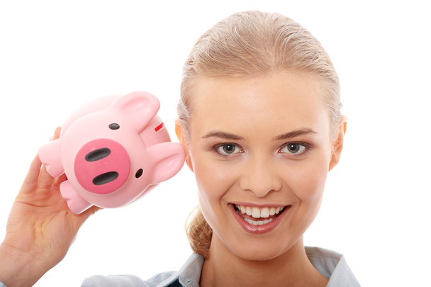 Businesswoman holding piggy bank - Zdjęcie, obraz