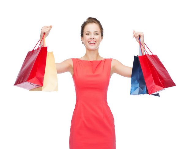 laughing elegant woman in dress with shopping bags - Fotó, kép