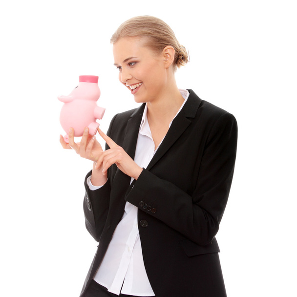Businesswoman holding piggy bank. Isolated on white background - Фото, изображение