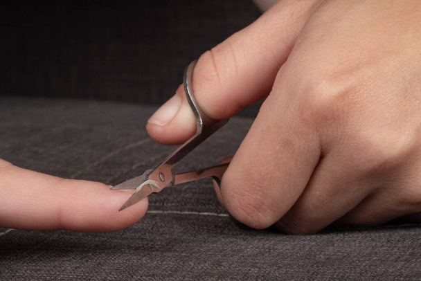 nail clipping with nail scissors closeup. - Foto, Imagen