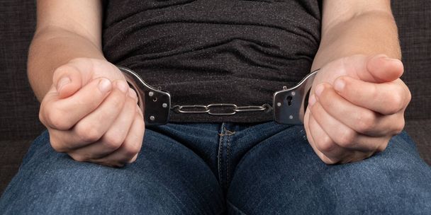 woman in handcuffs close up, arrest in crime concept. - 写真・画像