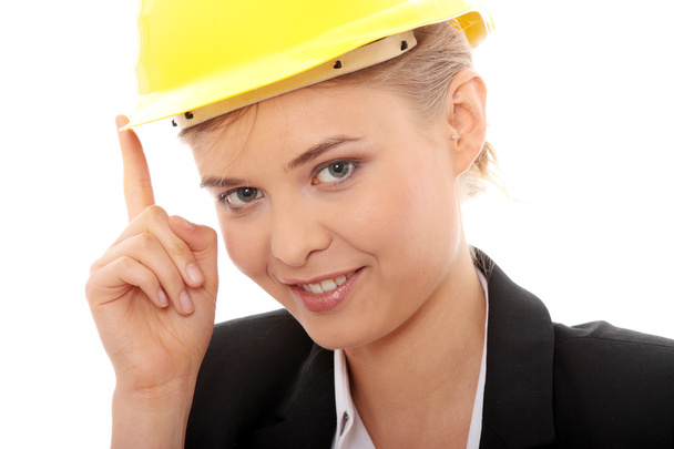 Portrait of confident female worker in helmet isolated on white background - 写真・画像