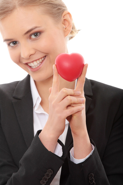 Young business woman holding heart shaped toy - Photo, Image