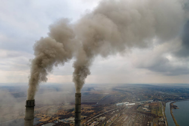 Letecký pohled na uhelné elektrárny vysoké trubky s černým kouřem pohybující se nahoru znečišťující atmosféru. - Fotografie, Obrázek
