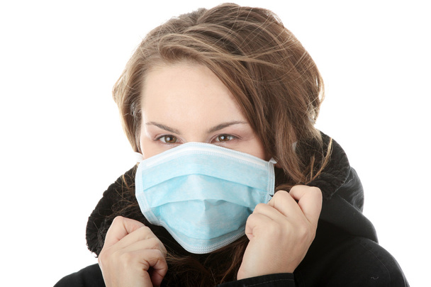 A model wearing a mask to prevent 'Swine Flu' infection. Isolated - Zdjęcie, obraz