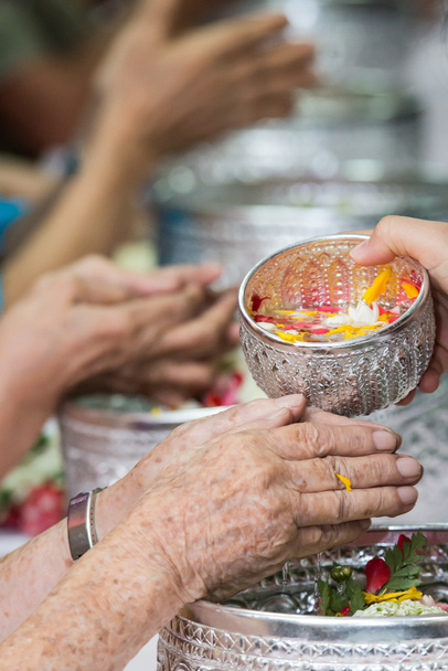 Despeje água nas mãos de anciãos reverenciados e dá bênção em
  - Foto, Imagem