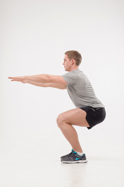 Man doing squats - Foto, immagini