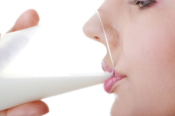Young happy woman drinking milk isolated on white background - Zdjęcie, obraz